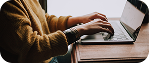 hands typing on laptop